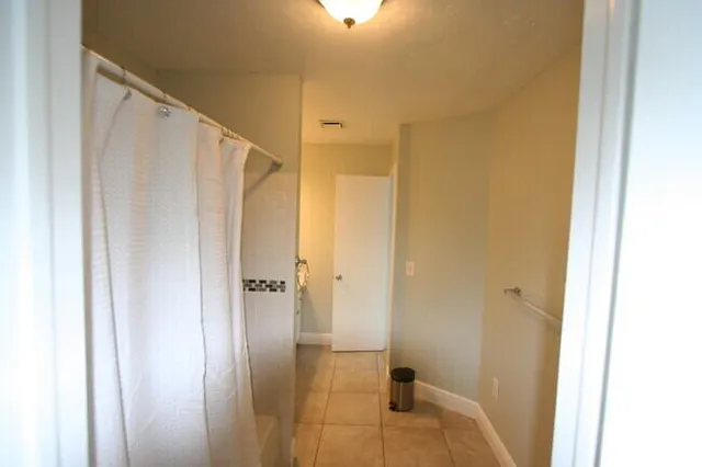 a bathroom with a shower and a sink