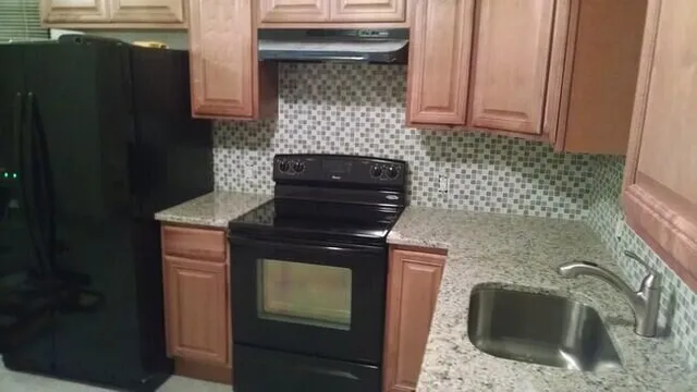 a kitchen with a sink stove and refrigerator
