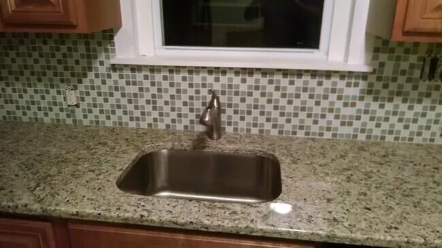 a bathroom with a sink and a granite counter top