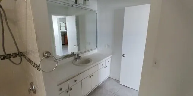 a bathroom with a double vanity sink and a mirror