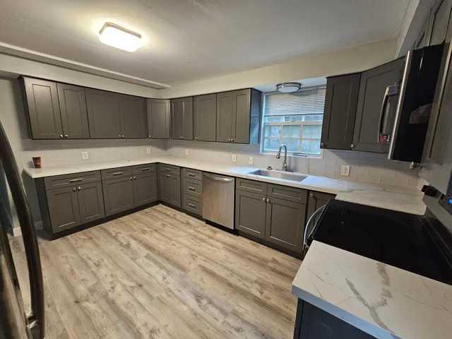 a kitchen with a sink a stove and refrigerator