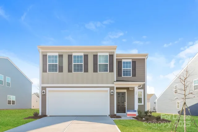 a view of house with backyard