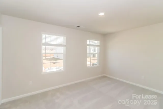 a bathroom with a granite countertop sink a toilet a mirror and a tub