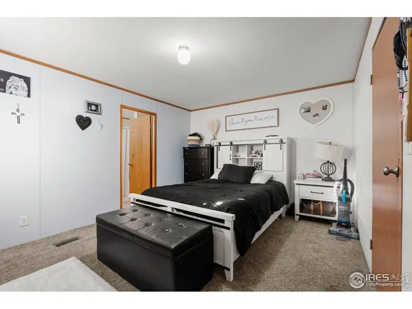 a bedroom with a bed and a night stand