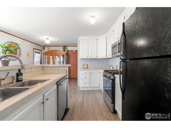 a kitchen with a refrigerator and a sink