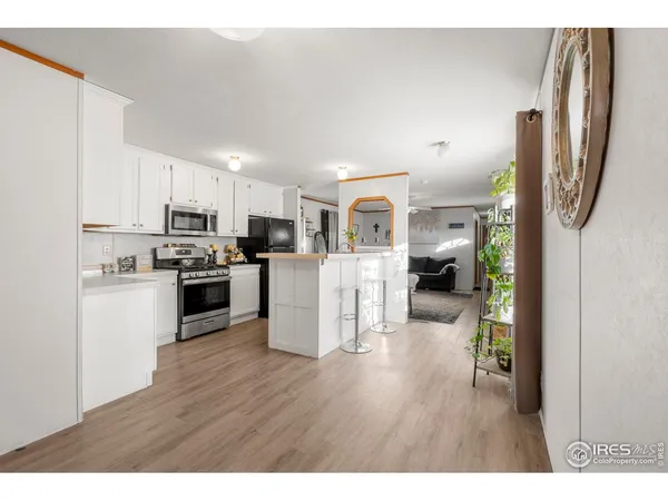 a kitchen view with stainless steel appliances refrigerator and cabinets