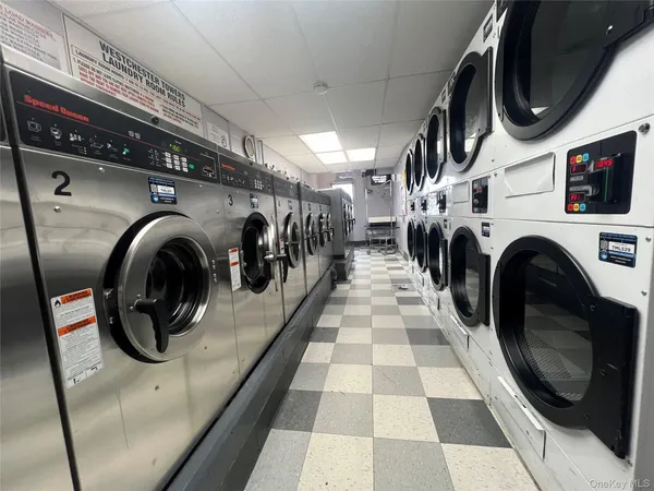 a view of a hallway with washer and dryer