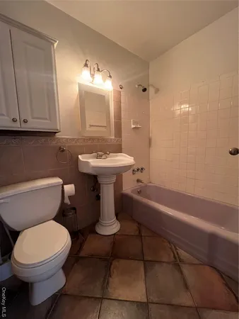 a bathroom with a sink a toilet and bathtub
