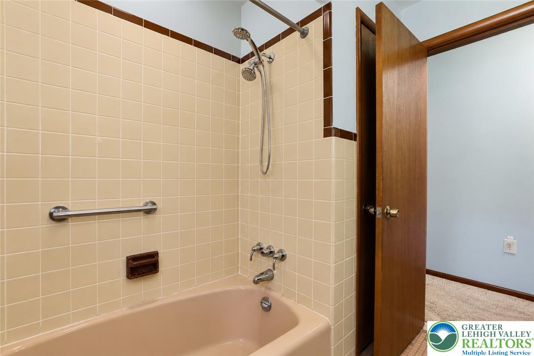 1539 Spring Garden Street Wilson, PA 18042 - Photo 22 of 34 Retro tile surrounds the tub shower combination in this classic bathroom space.