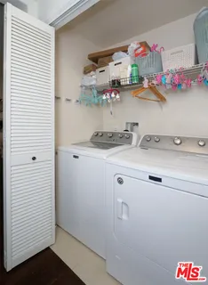 a utility room with sink dryer and washer