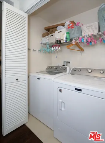 a utility room with sink dryer and washer