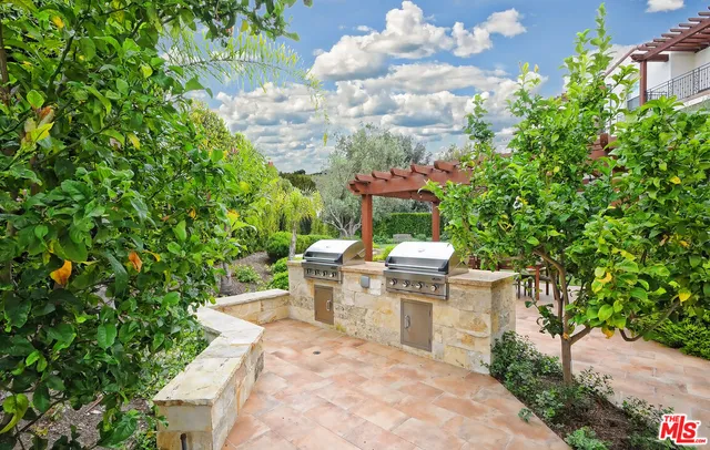 a view of a patio with table and chairs and potted plants