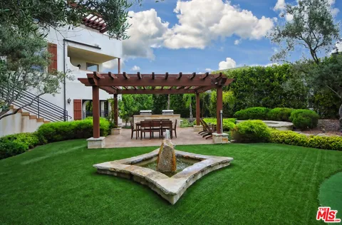 a view of a chairs and table in backyard of the house