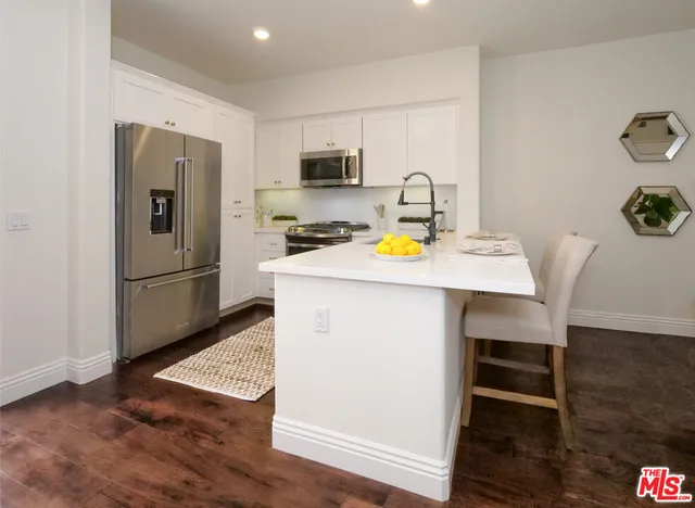 a view of kitchen with sink refrigerator and microwave