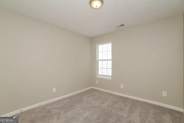 an empty room with windows and window