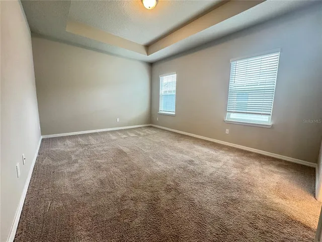 an empty room with a window and fireplace