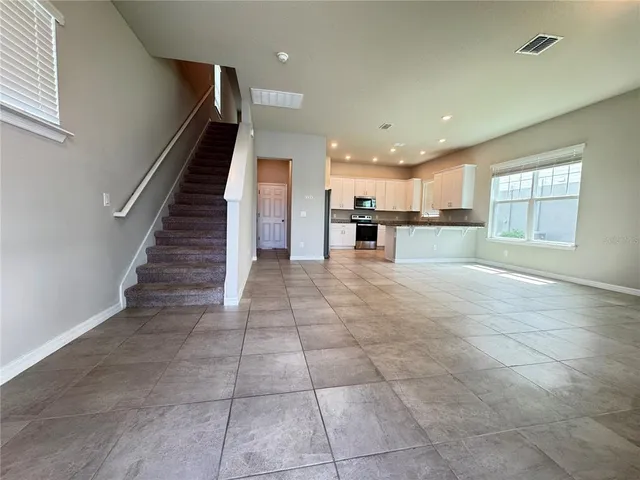 a view of a kitchen with an empty space and windows