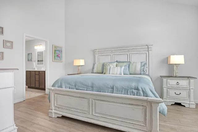 a bedroom with a large bed and a dresser