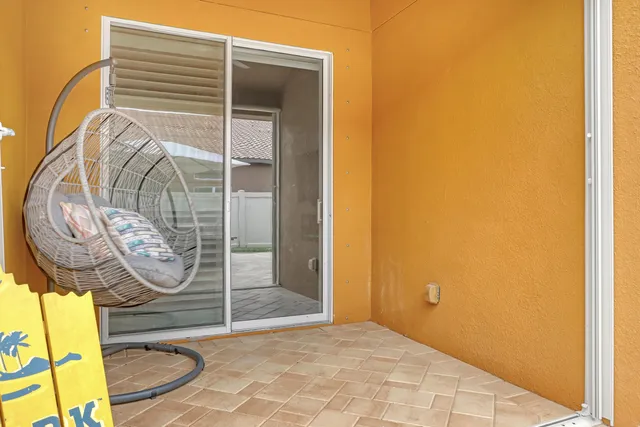 a backyard of a house with table and chairs