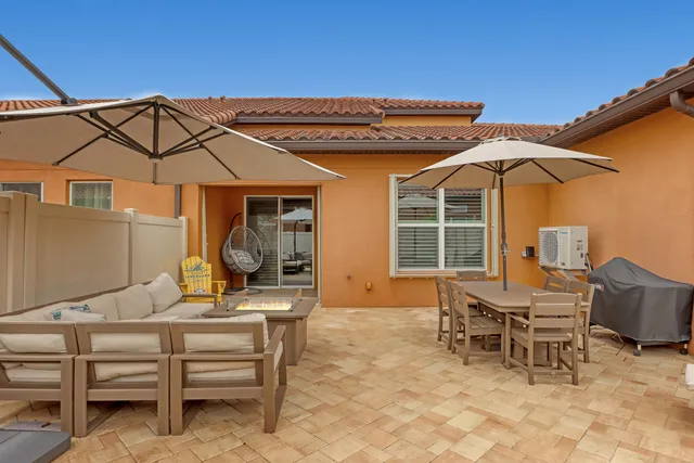 an aerial view of residential houses with outdoor space and ocean view