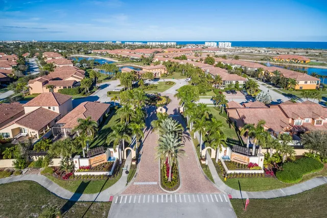 an aerial view of a house with a swimming pool a yard and a fountain