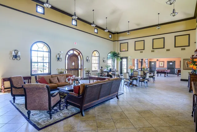 a living room with furniture a dining table and kitchen view