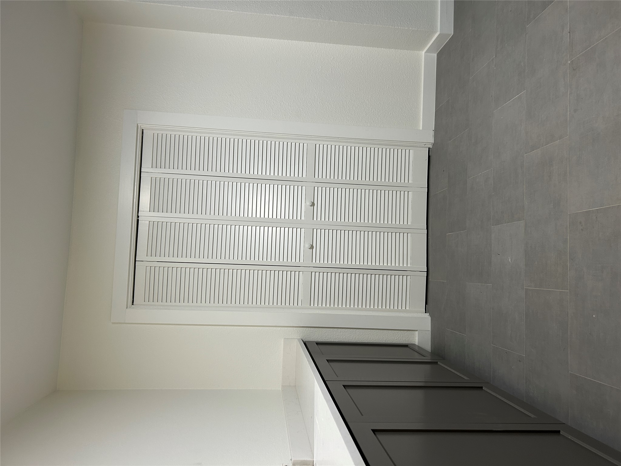 6502 South 1st Street, Unit 101 Austin, TX 78745 - Photo 2 of 12 Louvered bi-fold doors complemented by extensive built-in cabinetry with a light-toned countertop