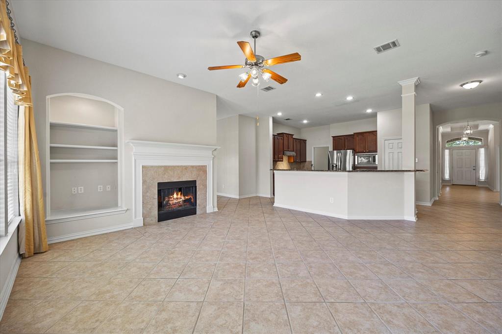 207 Leonard Way Fate, TX 75087 - Photo 17 of 31 a view of a livingroom with a kitchen and a fireplace