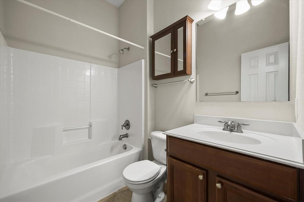 207 Leonard Way Fate, TX 75087 - Photo 21 of 31 a bathroom with a sink a toilet and shower