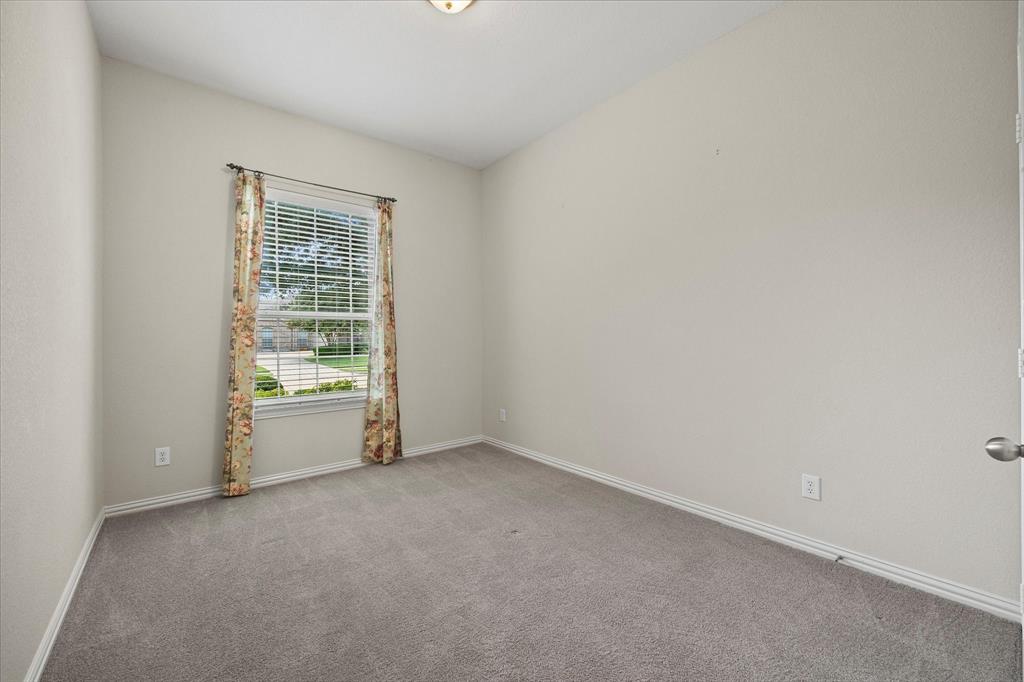 207 Leonard Way Fate, TX 75087 - Photo 22 of 31 a view of an empty room with a window
