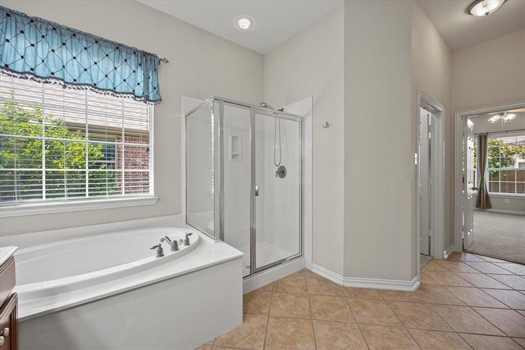 207 Leonard Way Fate, TX 75087 - Photo 6 of 31 a view of a bathroom with a tub shower and sink