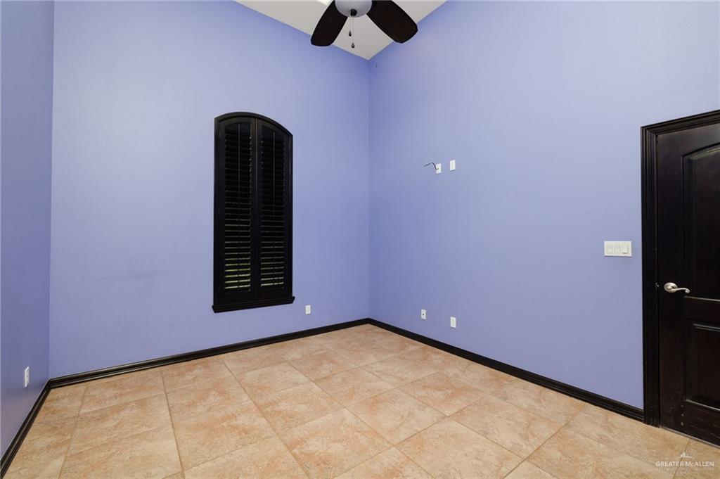 401 Ric Mar Street Edinburg, TX 78541 - Photo 14 of 18 Spacious room featuring vaulted ceilings, a ceiling fan, and tile flooring