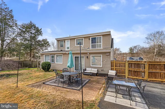 a view of a house with backyard porch and sitting area
