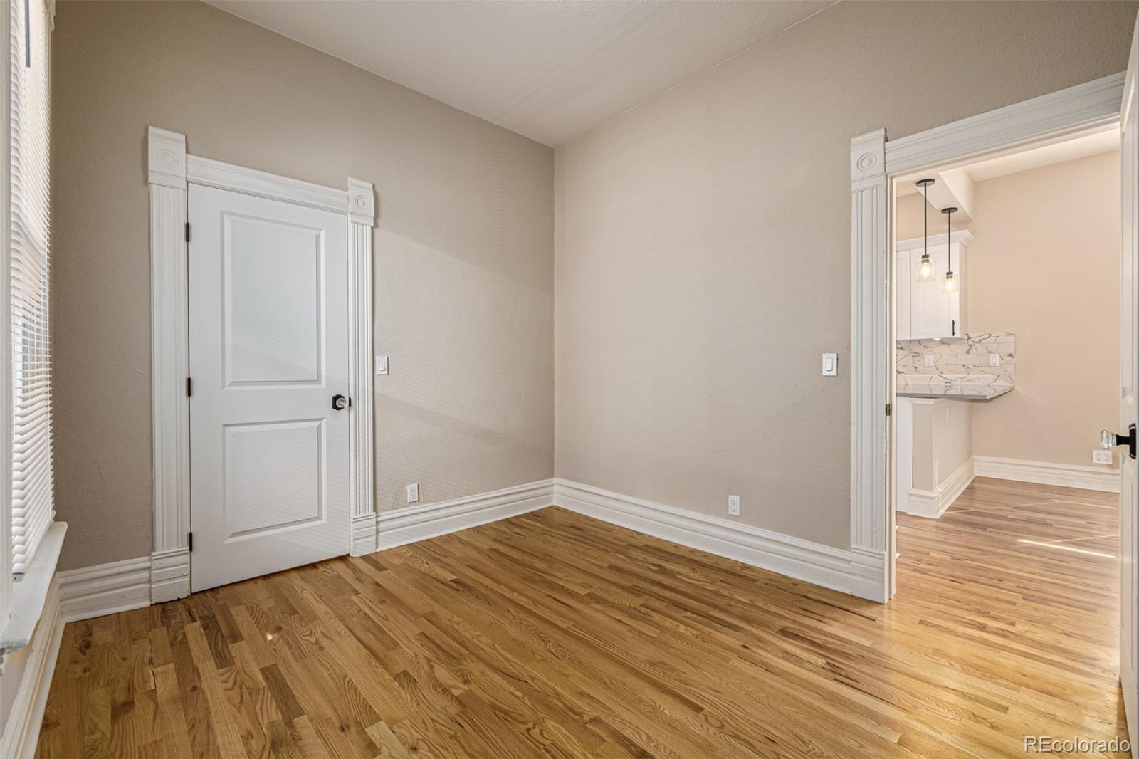 3854 Cook Street Denver, CO 80205 - Photo 17 of 42 a view of empty room with wooden floor