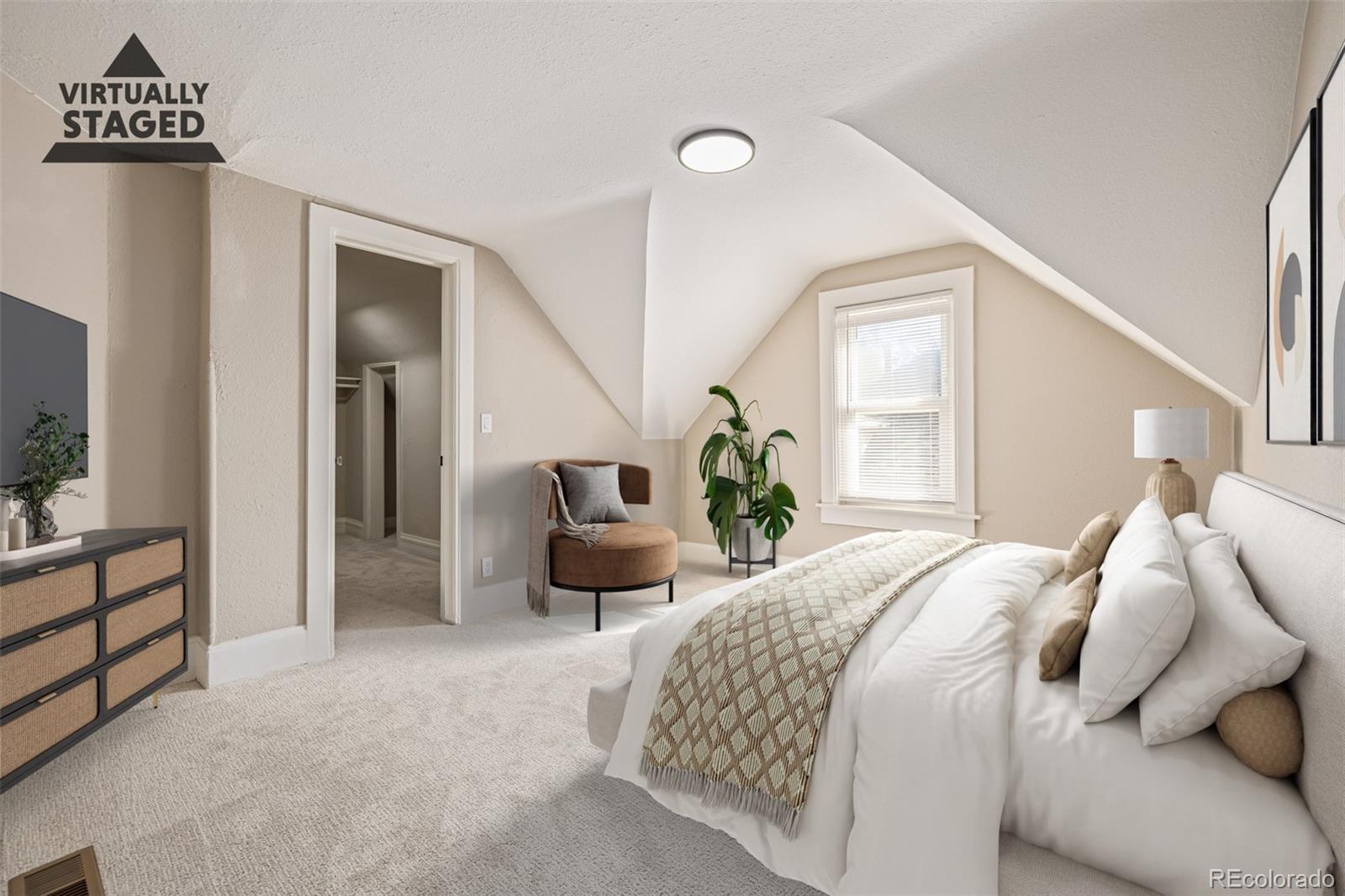 3854 Cook Street Denver, CO 80205 - Photo 19 of 42 a bedroom with a bed and a window