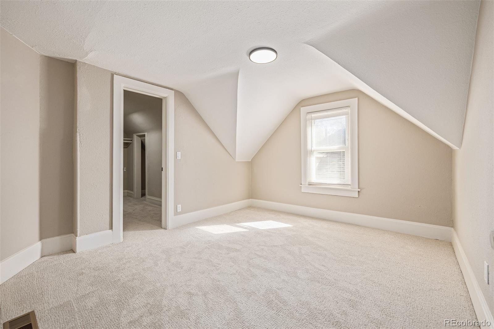 3854 Cook Street Denver, CO 80205 - Photo 20 of 42 an empty room with windows and closet