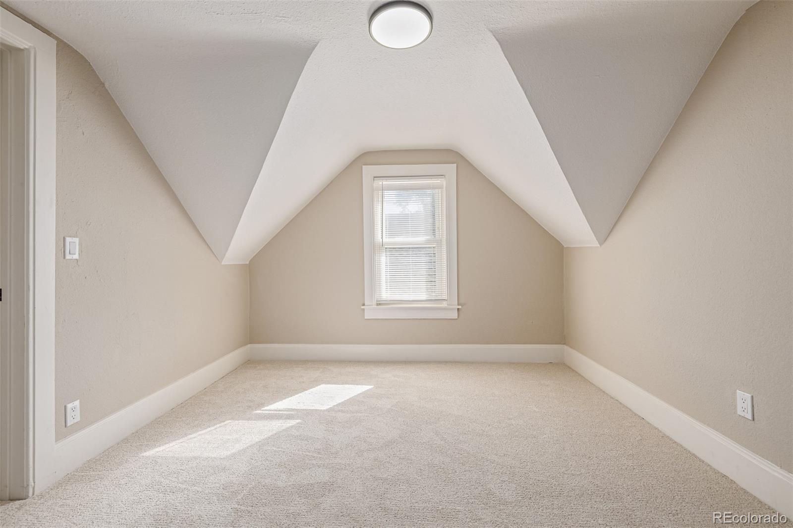 3854 Cook Street Denver, CO 80205 - Photo 21 of 42 an empty room with a window