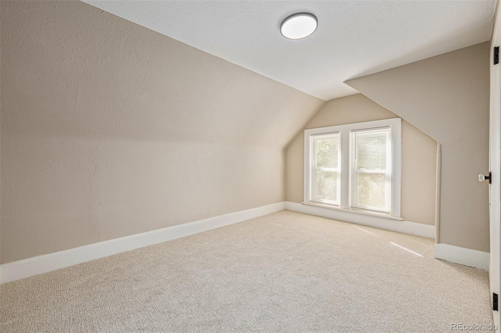 3854 Cook Street Denver, CO 80205 - Photo 27 of 42 an empty room with windows