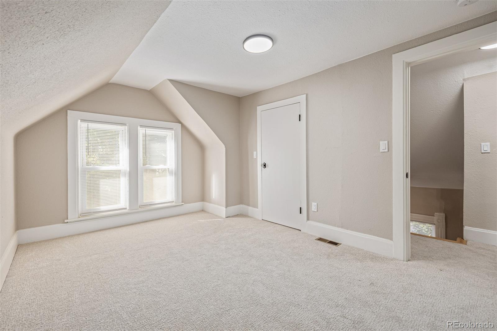 3854 Cook Street Denver, CO 80205 - Photo 28 of 42 an empty room with windows and closet