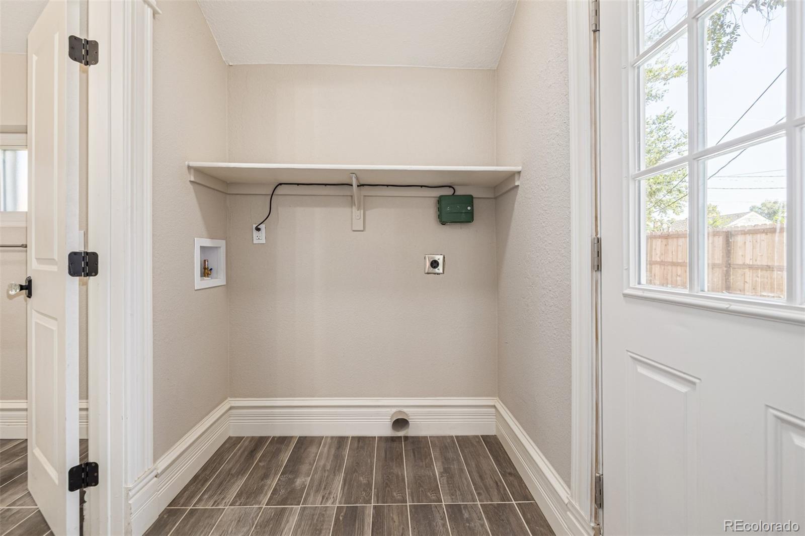 3854 Cook Street Denver, CO 80205 - Photo 30 of 42 a view of an empty room with a window