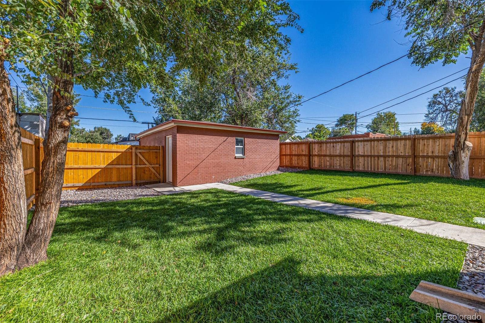 3854 Cook Street Denver, CO 80205 - Photo 34 of 42 a view of a backyard with a small cabin