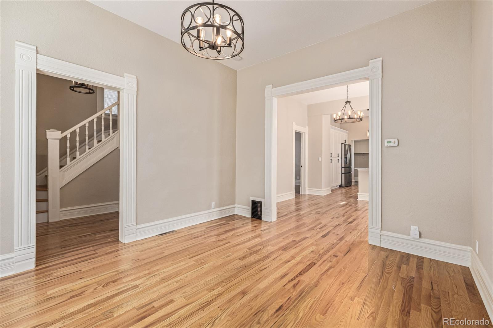 3854 Cook Street Denver, CO 80205 - Photo 7 of 42 wooden floor in a hallway with a window
