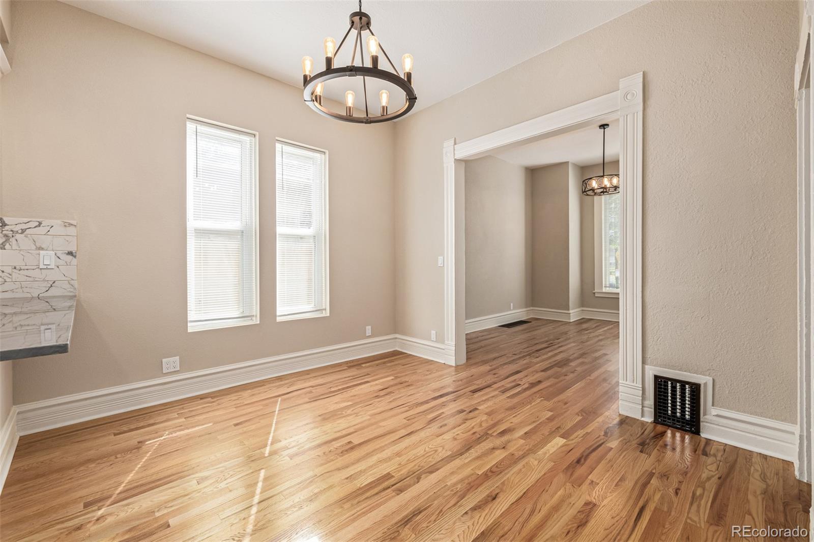 3854 Cook Street Denver, CO 80205 - Photo 8 of 42 a view of empty room with wooden floor and window