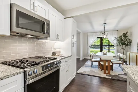 a kitchen with a stove a sink and a microwave