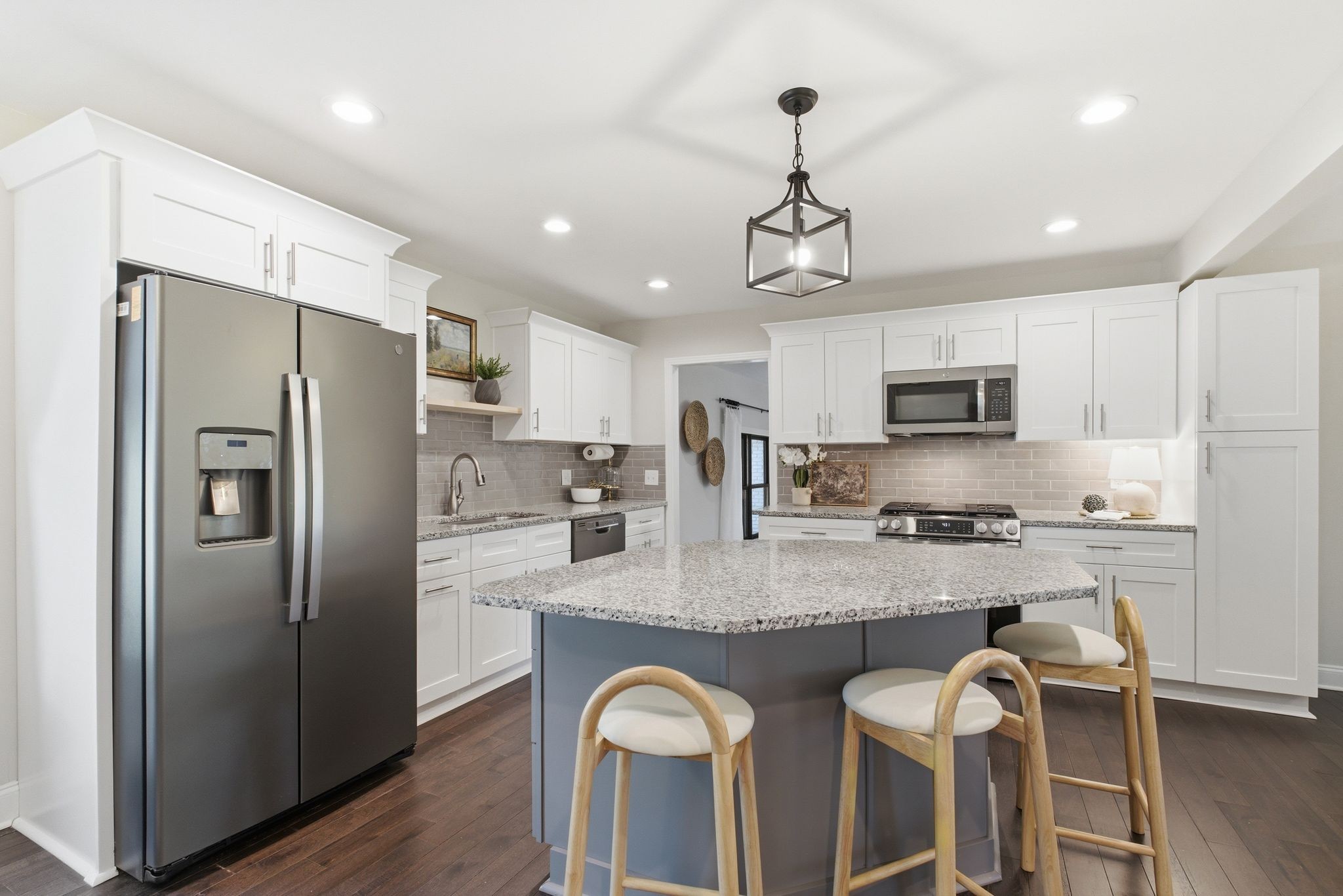 301 Rosebrook Drive Gallatin, TN 37066 - Photo 17 of 49 a kitchen with stainless steel appliances granite countertop a refrigerator a stove a sink dishwasher a dining table and chairs with wooden floor