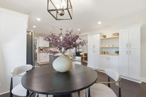 a view of a dining room with furniture and wooden floor