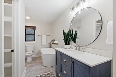 a bathroom with a toilet sink and mirror