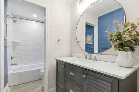 a bathroom with a sink a vanity and a mirror