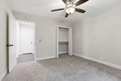 a view of an empty room with a ceiling fan