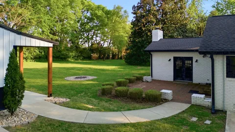 a view of a house with a backyard